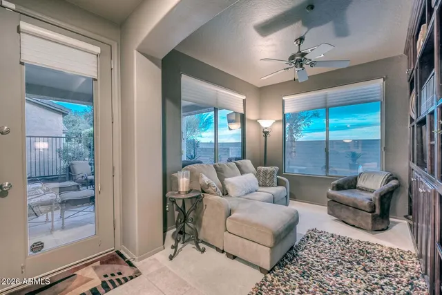 a living room with lots of furniture and a view of kitchen