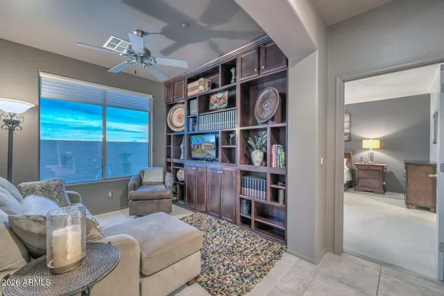 a bedroom with a bed and large windows