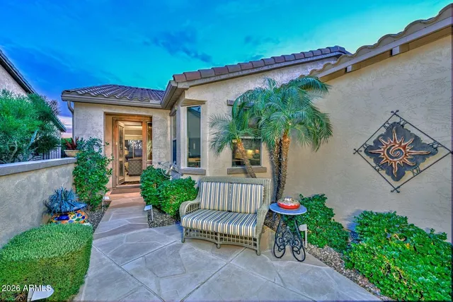 an outdoor living room with furniture and a fireplace