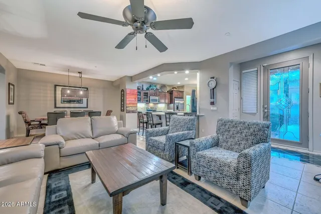 a living room with lots of furniture and kitchen view