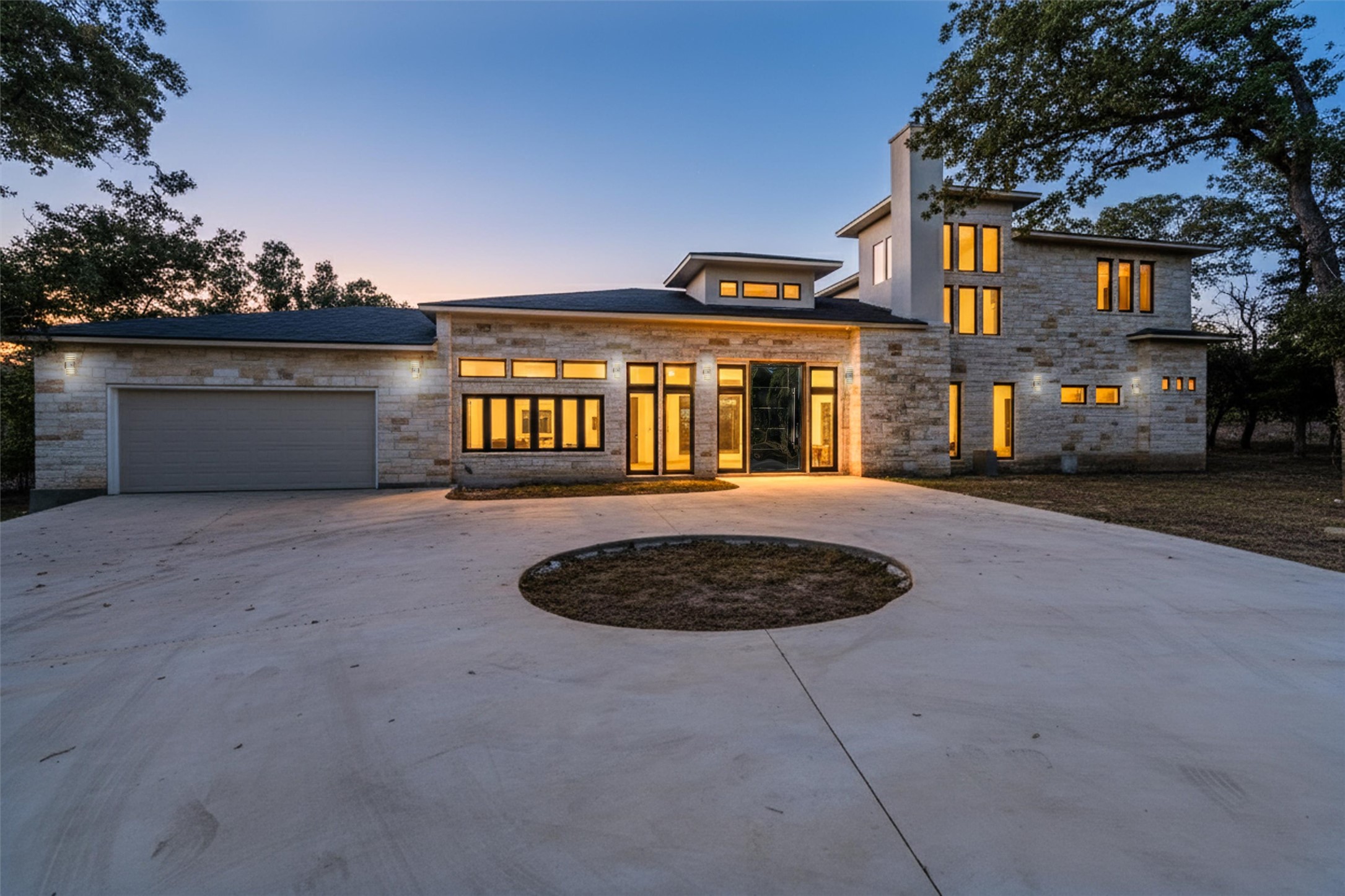 265 Maple Leaf Trail Elgin, TX 78621 - Photo 1 of 1 View of front of property featuring curved driveway, stone siding, a chimney, and an attached garage