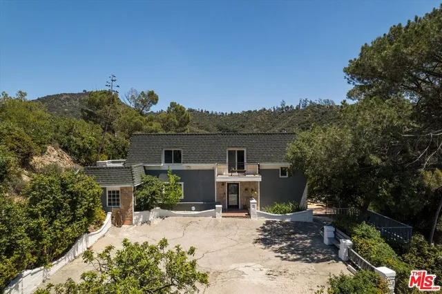 a view of a house with furniture and a fire pit