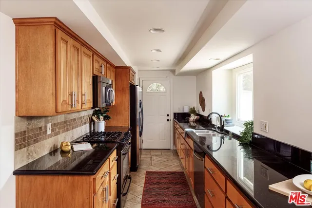 a kitchen with a sink stove and refrigerator