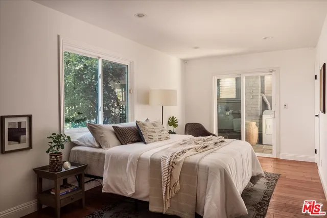 a bedroom with a bed and a large window