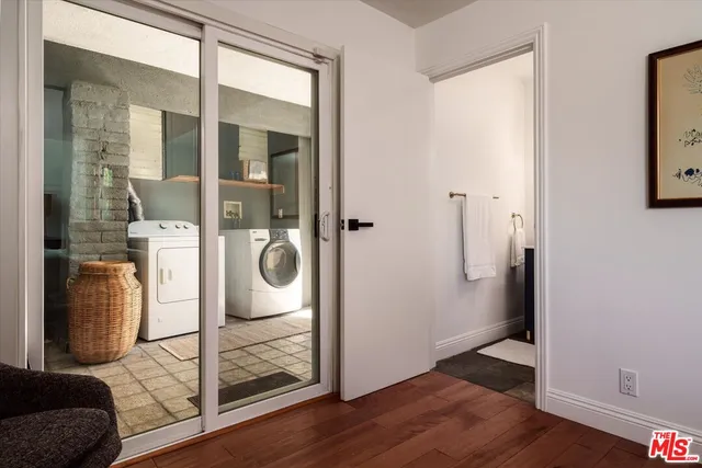 a bathroom with a glass shower door and a window