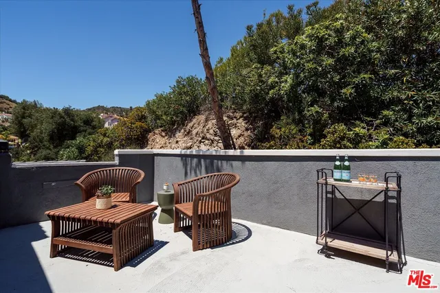 a view of a chair and table in the balcony