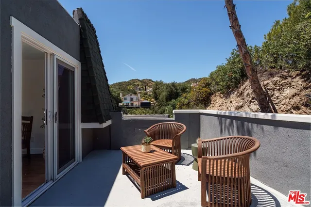 a view of a balcony with furniture