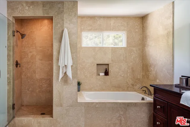 a bathroom with a bathtub and a shower