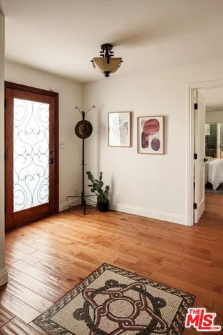 a view of a room with window and hardwood floor