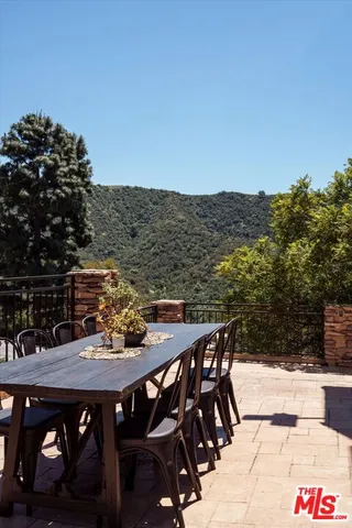 a view of dinning table and chairs on the terrace