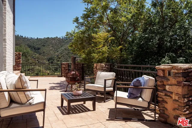 a view of a chairs and table in the roof deck
