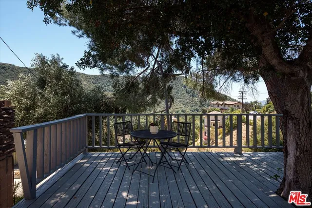 a view of balcony with wooden floor and outdoor seating