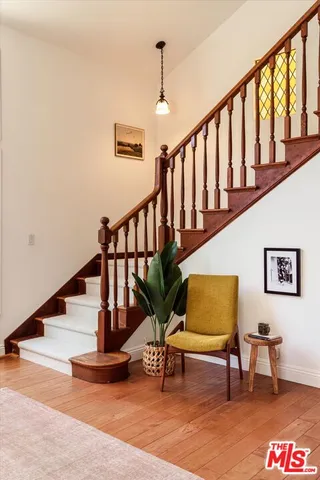 a view of staircase with furniture and a window
