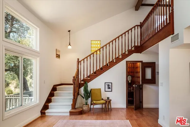a view of entryway and hall with wooden floor