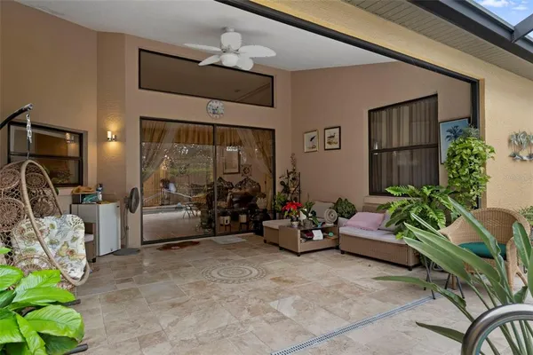 a living room with furniture gym equipment and a chandelier