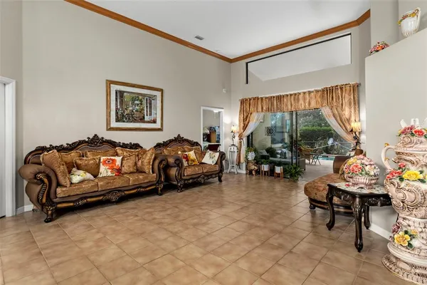 a bedroom with furniture and a large window