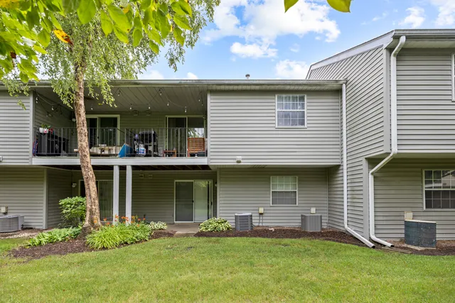 a view of a house with a yard and sitting area