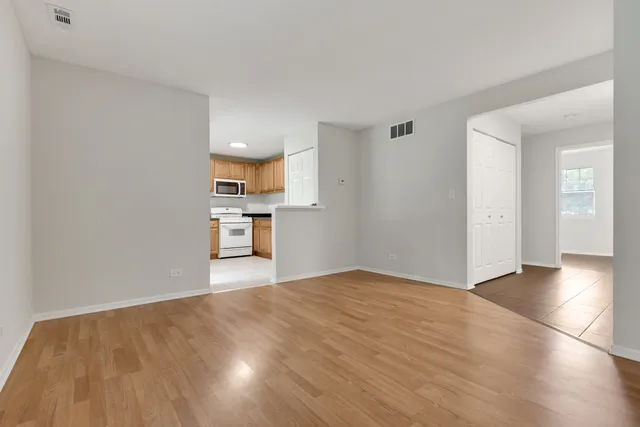a view of a kitchen with a sink and a refrigerator
