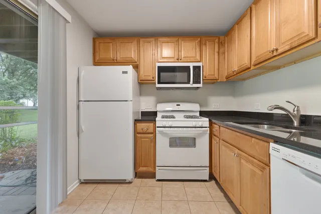 a kitchen with a refrigerator sink and microwave