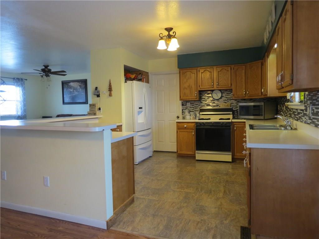 127 Alderson Road Saxonburg, PA 16056 - Photo 2 of 25 The kitchen has plenty of room for more than one cook! It has a stylish updated backsplash and tons of cabinet space.