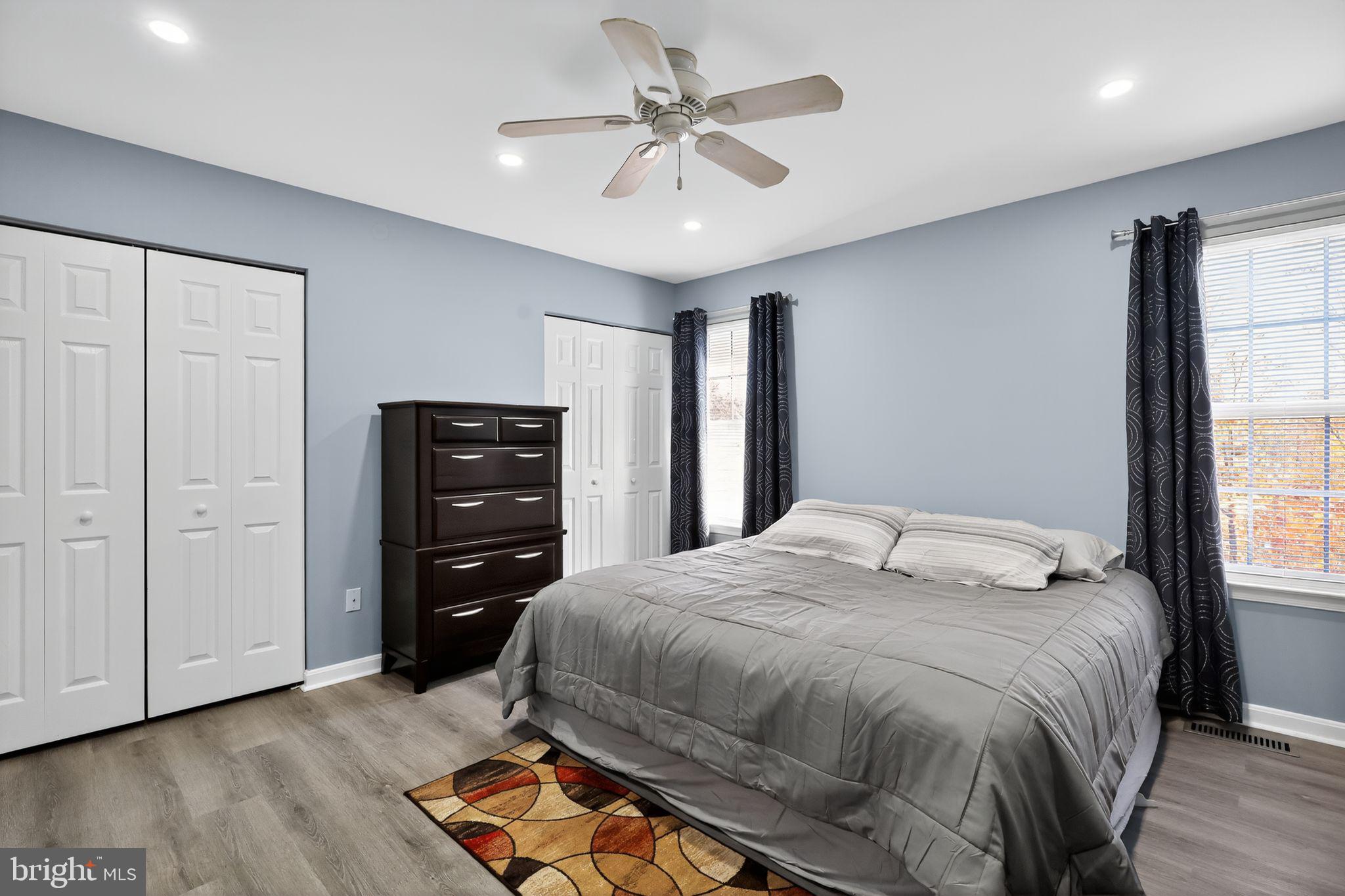 45481 Bluemont Junction Square Sterling, VA 20164 - Photo 16 of 30 a bedroom with a bed and a chandelier