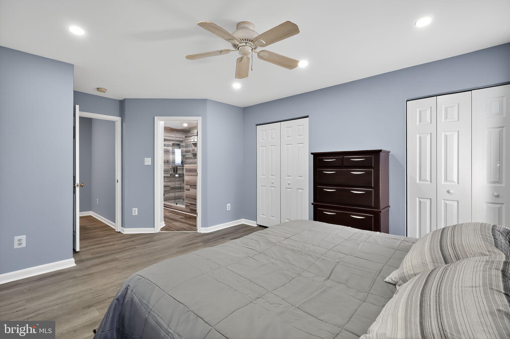 45481 Bluemont Junction Square Sterling, VA 20164 - Photo 17 of 30 a bedroom with a bed and a chandelier