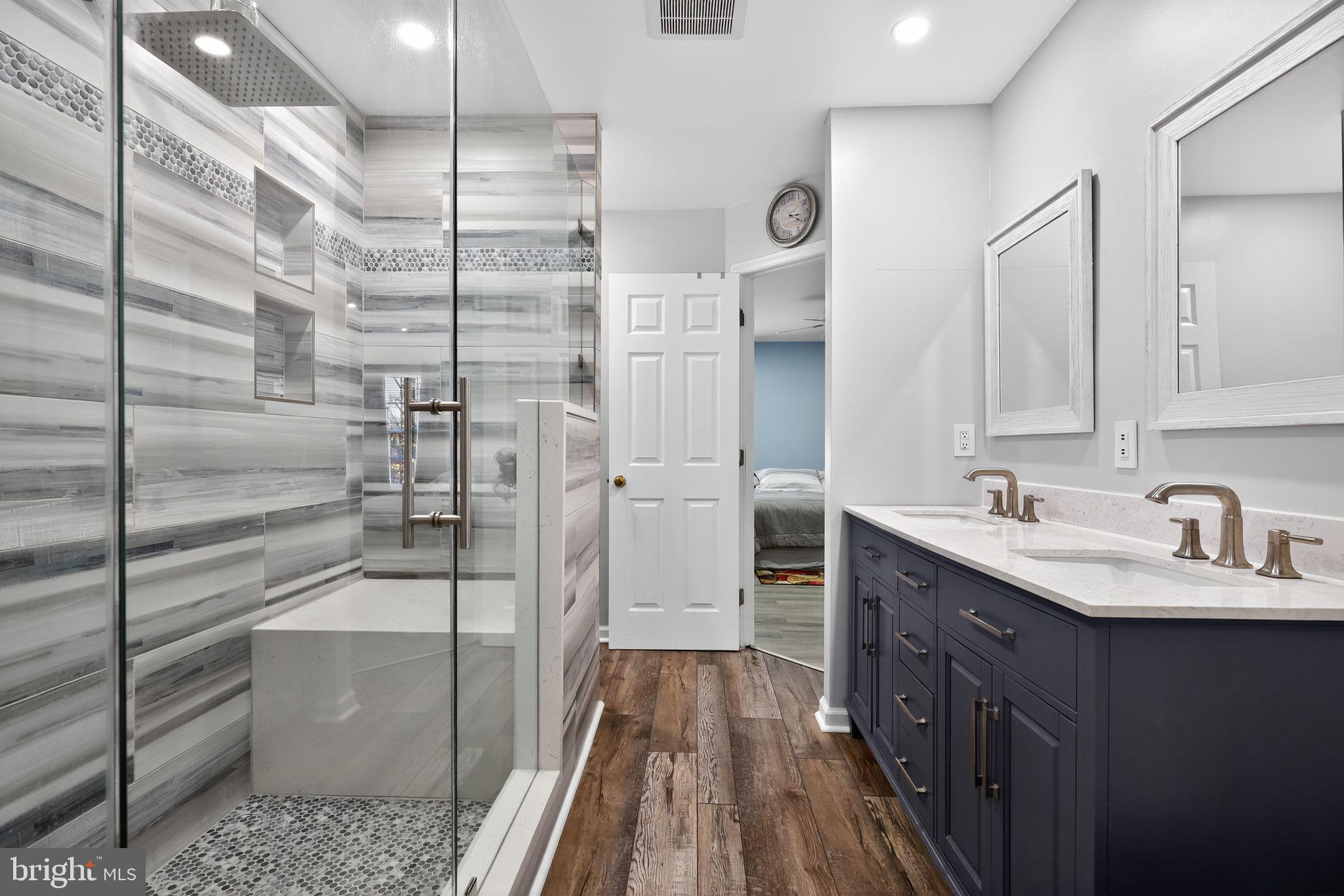 45481 Bluemont Junction Square Sterling, VA 20164 - Photo 19 of 30 a bathroom with a double vanity sink a toilet and a mirror