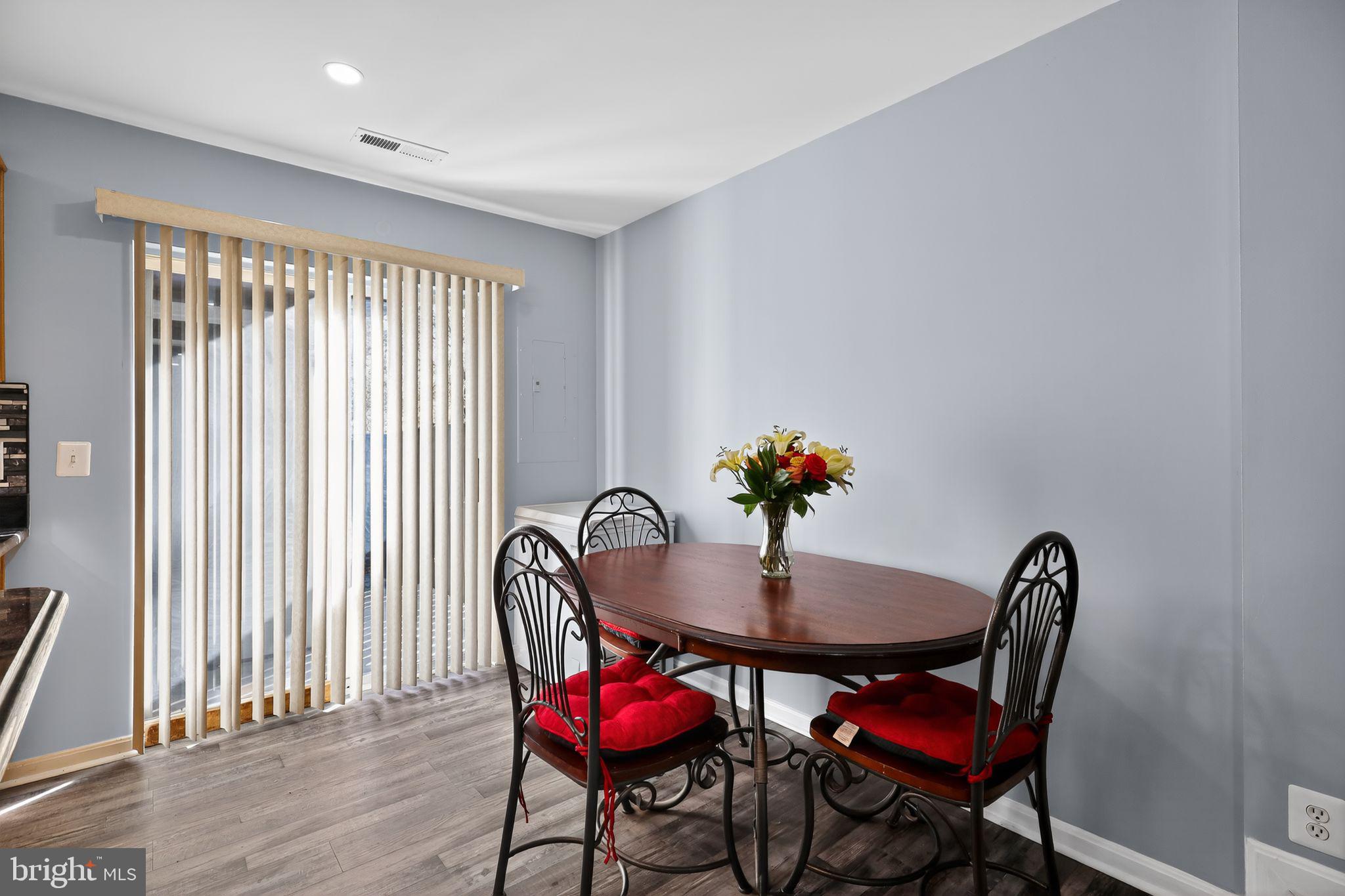 45481 Bluemont Junction Square Sterling, VA 20164 - Photo 8 of 30 a view of a dining room with furniture and wooden floor