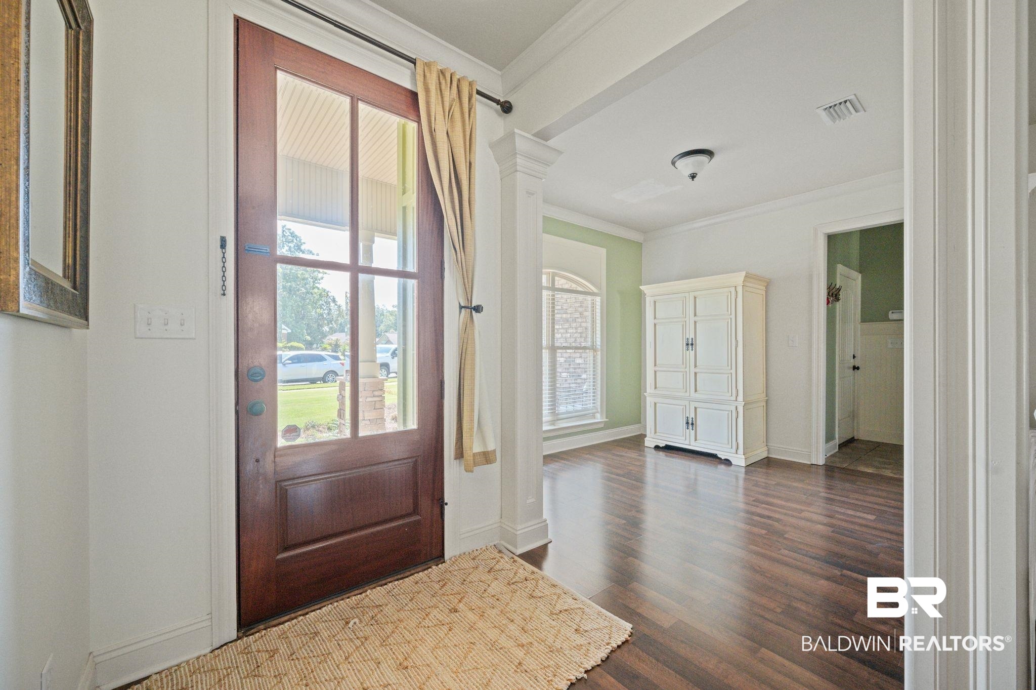 3879 Symphony Way West Semmes, AL 36575 - Photo 4 of 34 Entrance foyer with dark hardwood / wood-style flooring, decorative columns, and crown molding