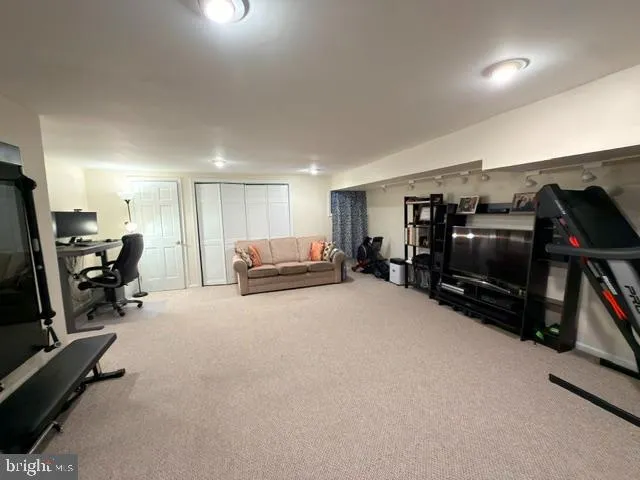a view of a livingroom with furniture and a flat screen tv