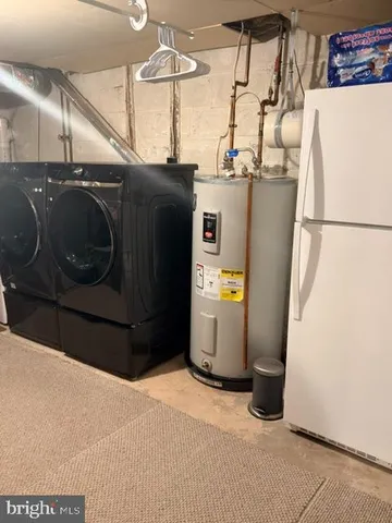 a kitchen with a refrigerator and washer