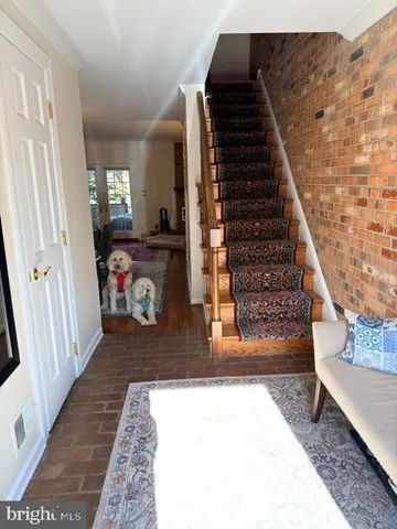 a view of an entryway with wooden floor