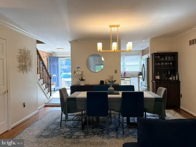 a dining room with furniture and wooden floor
