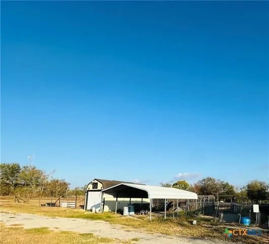 a front view of a building with a ocean view