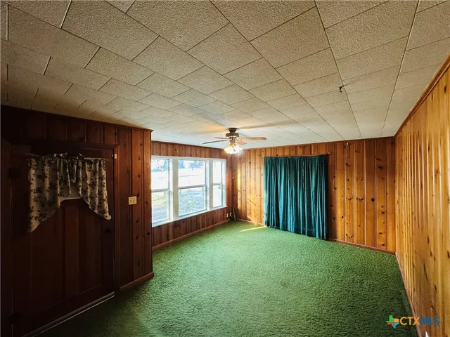 a large kitchen with kitchen island a counter space a sink a window and stainless steel appliances