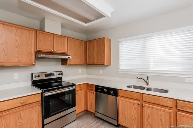 a kitchen with stainless steel appliances granite countertop a sink a stove and a microwave
