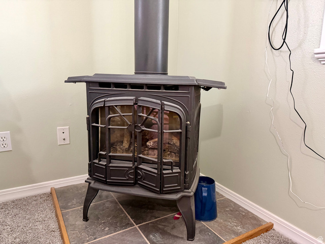 202 375 West Providence, UT 84332 - Photo 21 of 61 Detailed view of a wood stove and baseboards