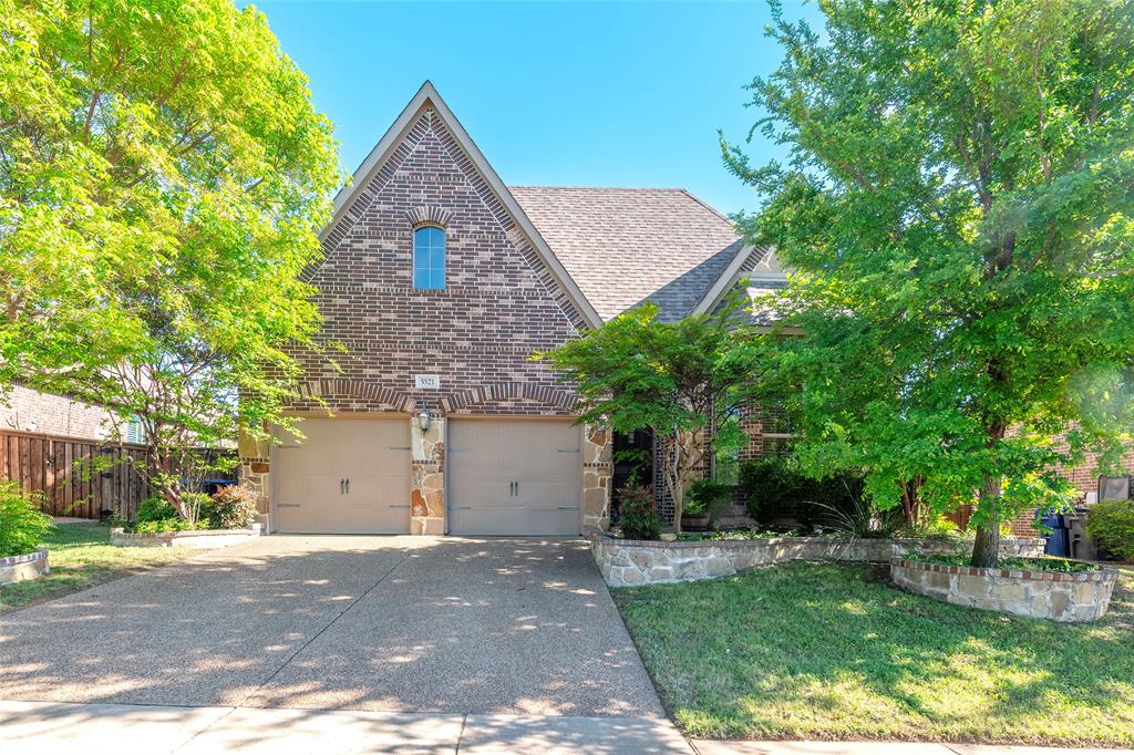 5521 Ridgepass Lane McKinney, TX 75071 - Photo 1 of 1 View of front of home featuring brick siding, driveway, a shingled roof, stone siding, and a garage