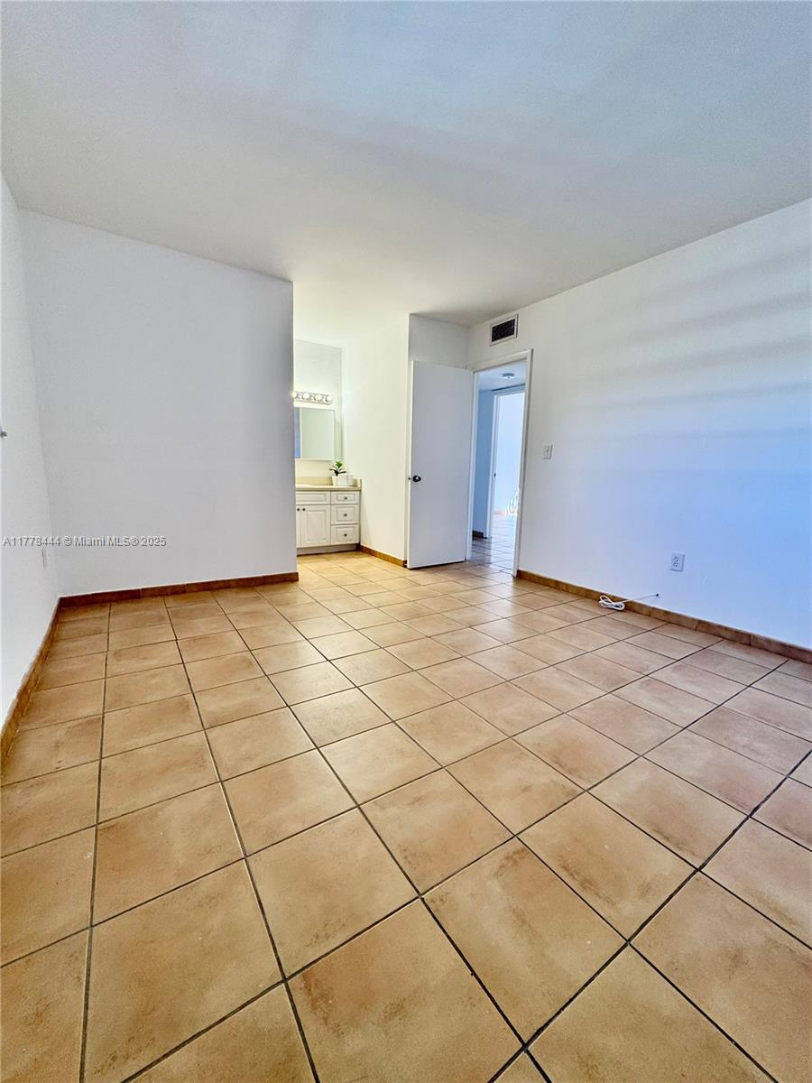 1075 West 68th Street, Unit 314 Hialeah, FL 33014 - Photo 12 of 27 a view of a livingroom with an empty space and a window