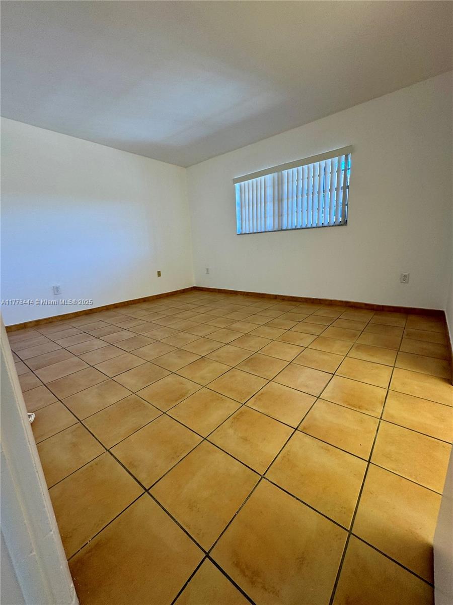 1075 West 68th Street, Unit 314 Hialeah, FL 33014 - Photo 13 of 27 a view of an empty room and window