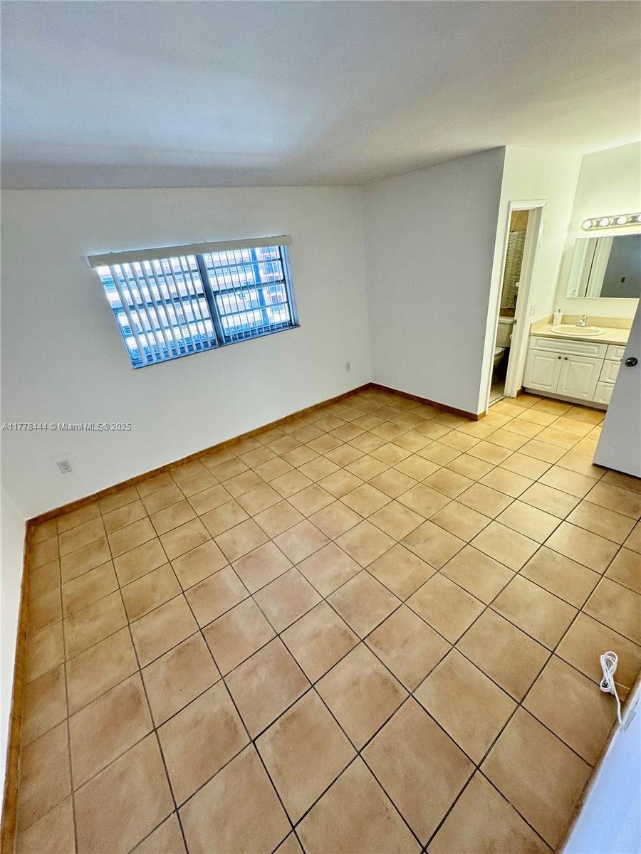 1075 West 68th Street, Unit 314 Hialeah, FL 33014 - Photo 14 of 27 a view of an empty room and a window