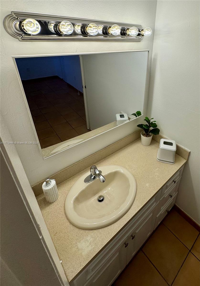 1075 West 68th Street, Unit 314 Hialeah, FL 33014 - Photo 16 of 27 a bathroom with a sink and a mirror