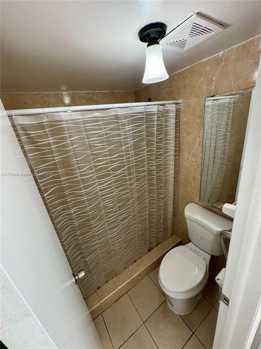 1075 West 68th Street, Unit 314 Hialeah, FL 33014 - Photo 17 of 27 a bathroom with a toilet