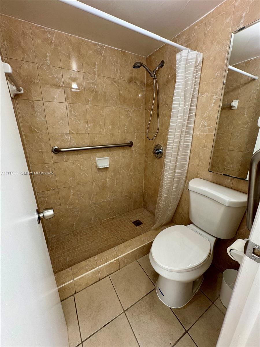 1075 West 68th Street, Unit 314 Hialeah, FL 33014 - Photo 18 of 27 a bathroom with a toilet and a shower