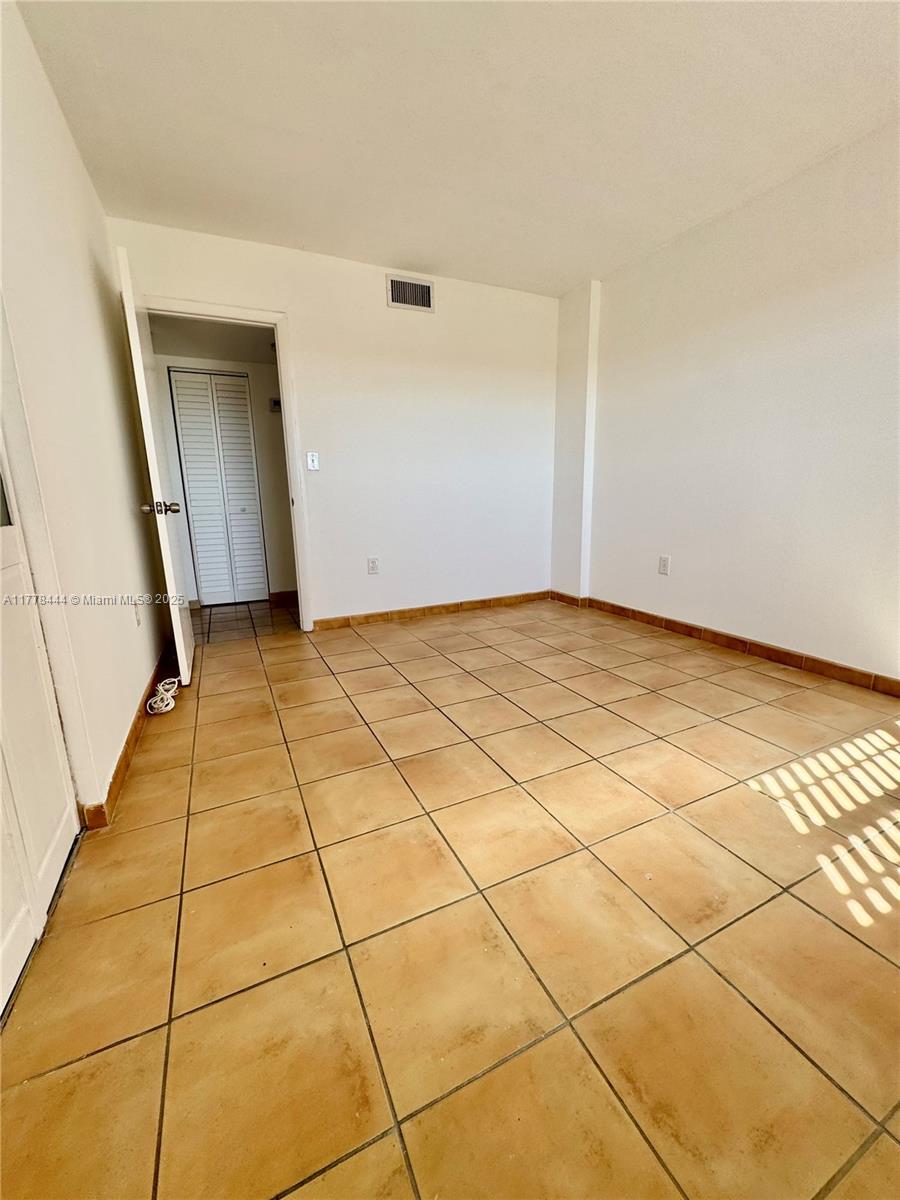 1075 West 68th Street, Unit 314 Hialeah, FL 33014 - Photo 22 of 27 a view of a livingroom with an empty space and a window