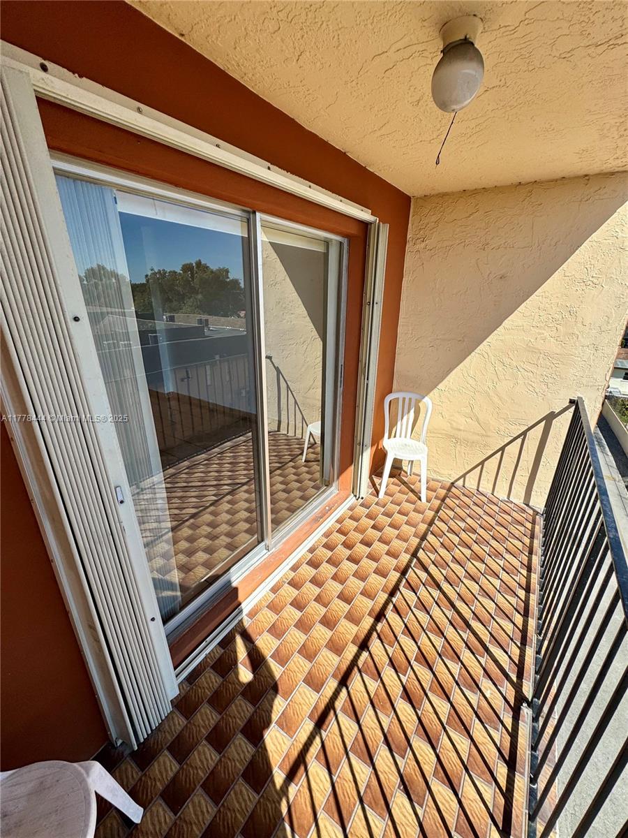 1075 West 68th Street, Unit 314 Hialeah, FL 33014 - Photo 24 of 27 a balcony view with a outdoor seating