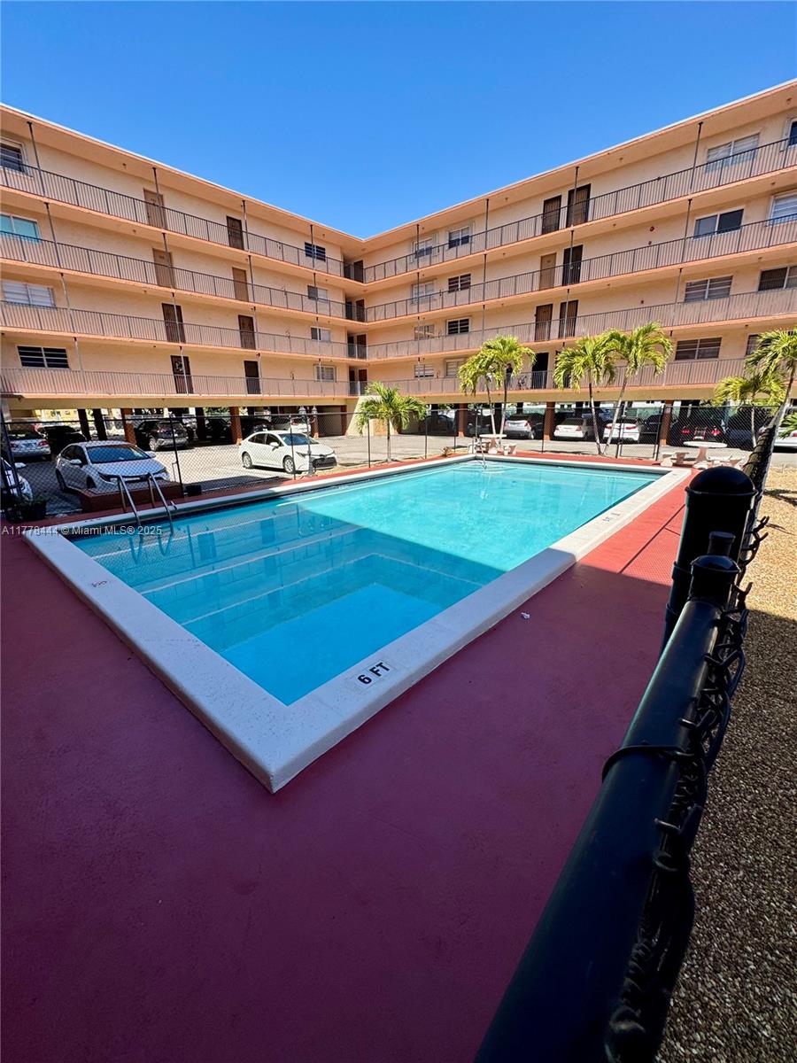 1075 West 68th Street, Unit 314 Hialeah, FL 33014 - Photo 27 of 27 a view of swimming pool with outdoor seating and city view