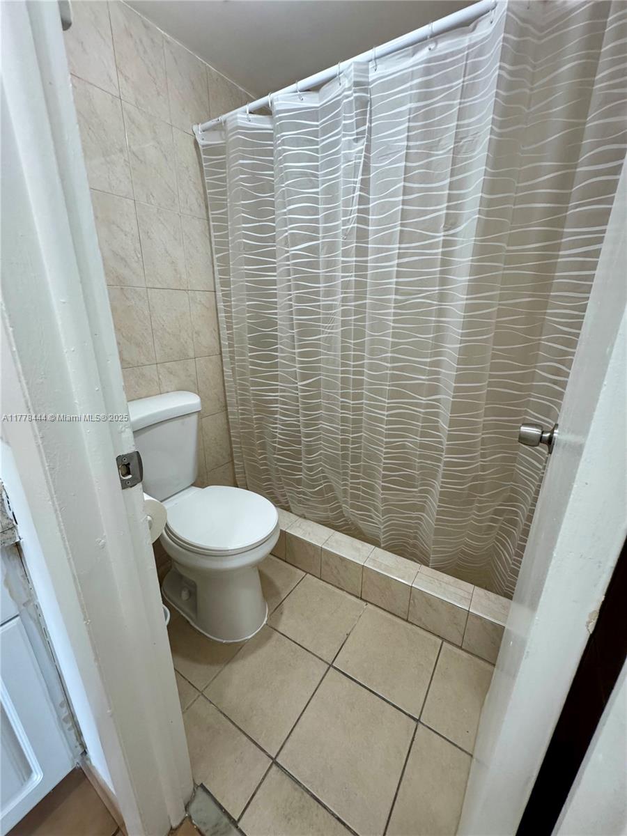 1075 West 68th Street, Unit 314 Hialeah, FL 33014 - Photo 8 of 27 a bathroom with a toilet and a shower