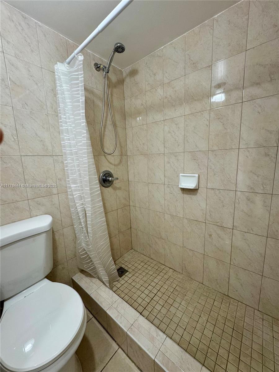 1075 West 68th Street, Unit 314 Hialeah, FL 33014 - Photo 9 of 27 a bathroom with a toilet and shower