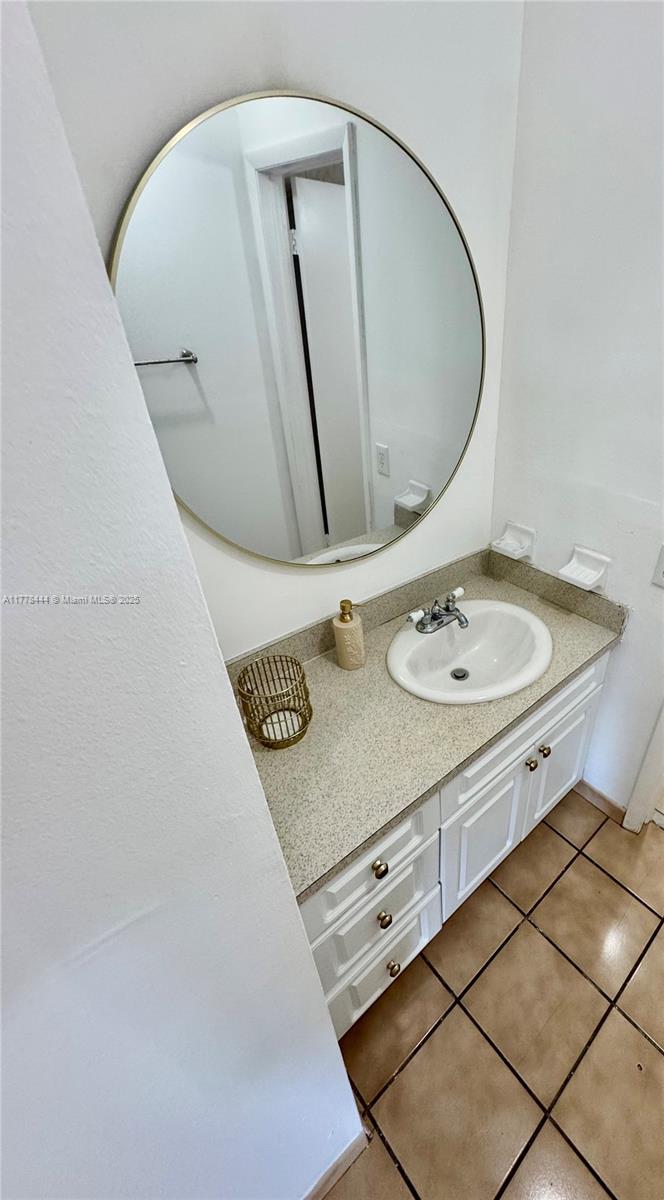 1075 West 68th Street, Unit 314 Hialeah, FL 33014 - Photo 10 of 27 a bathroom with a sink a mirror and vanity